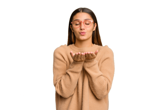 Young Indian woman isolated cutout removal background folding lips and holding palms to send air kiss.