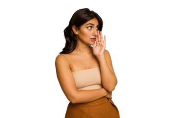 Young Indian woman isolated on green chroma background is saying a secret hot braking news and looking aside