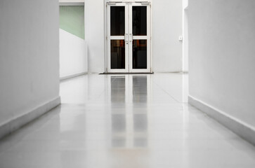 Door inside bright room. Empty room with white walls and light floor