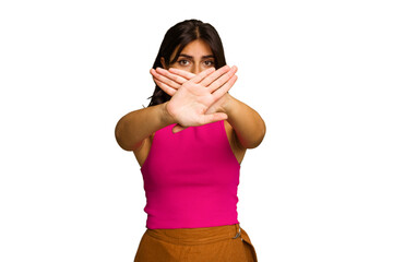 Young Indian woman isolated on green chroma background doing a denial gesture