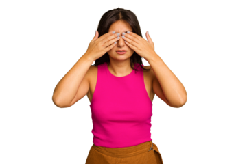 Young Indian woman isolated on green chroma background afraid covering eyes with hands.