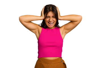 Young Indian woman isolated on green chroma background covering ears with hands trying not to hear too loud sound.