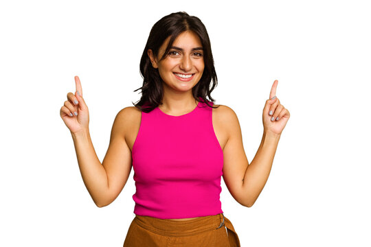 Young Indian woman isolated on green chroma background indicates with both fore fingers up showing a blank space.