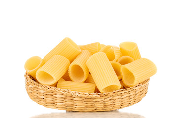 Several raw yellow cannelloni in a straw plate, macro, isolated on white background.