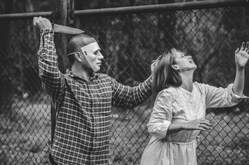 A serial killer scene is about to kill an Asian woman,concept thriller scene,Halloween festival