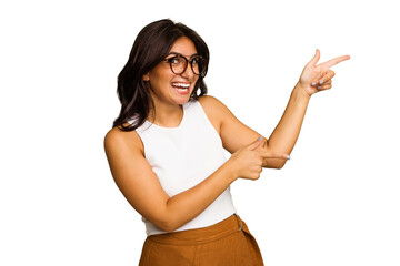 Young Indian woman isolated on green chroma background excited pointing with forefingers away.