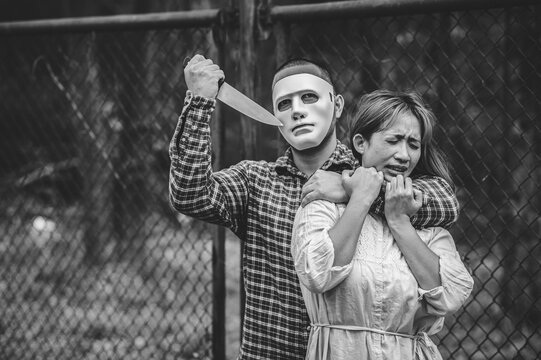 A serial killer scene is about to kill an Asian woman,concept thriller scene,Halloween festival