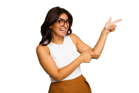Young Indian woman isolated on green chroma background excited pointing with forefingers away.
