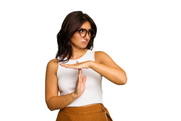 Young Indian woman isolated on green chroma background showing a timeout gesture.