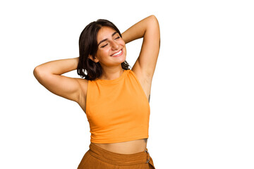 Young Indian woman isolated on green chroma background feeling confident, with hands behind the head.