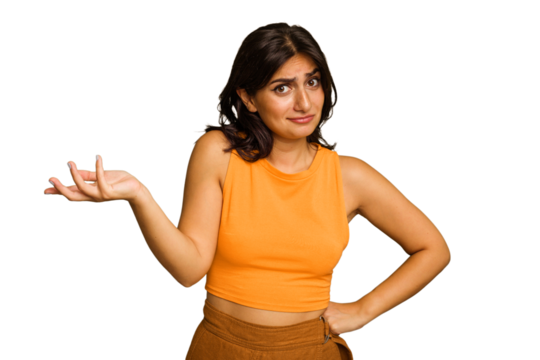 Young Indian woman isolated on green chroma background doubting and shrugging shoulders in questioning gesture.