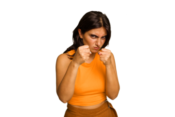 Young Indian woman isolated on green chroma background showing fist to camera, aggressive facial expression.