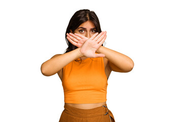 Young Indian woman isolated on green chroma background doing a denial gesture