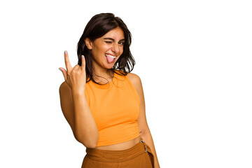 Young Indian woman isolated on green chroma background showing rock gesture with fingers