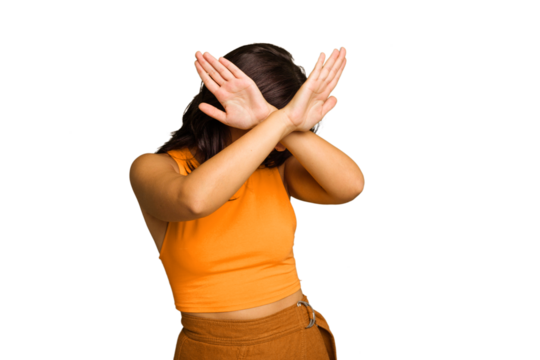 Young Indian woman isolated on green chroma background keeping two arms crossed, denial concept.