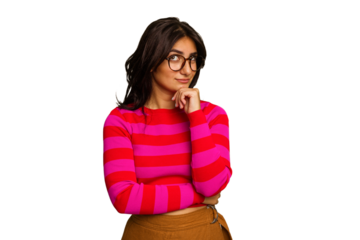 Young Indian woman isolated on green chroma background looking sideways with doubtful and skeptical expression.