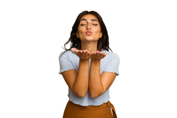 Young Indian woman isolated on green chroma background folding lips and holding palms to send air kiss.