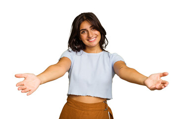 Young Indian woman isolated on green chroma background showing a welcome expression.