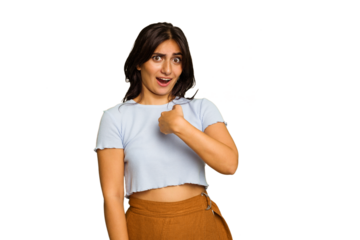 Young Indian woman isolated on green chroma background surprised pointing with finger, smiling broadly.