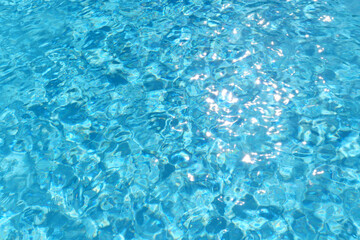 Fototapeta na wymiar Swimming pool clear water with sun reflection.
