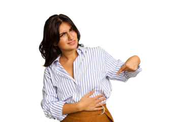 Young Indian woman isolated on green chroma background having a liver pain, stomach ache.