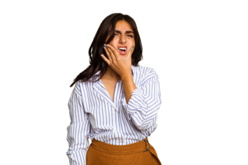 Young Indian woman isolated on green chroma background having a strong teeth pain, molar ache.