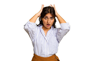 Young Indian woman isolated on green chroma background screaming, very excited, passionate,...