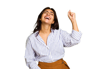 Young Indian woman isolated on green chroma background celebrating a victory, passion and...