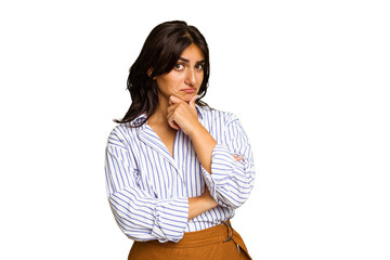 Young Indian woman isolated on green chroma background thinking and looking up, being reflective,...