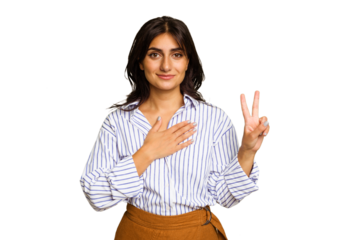 Young Indian woman isolated on green chroma background taking an oath, putting hand on chest.