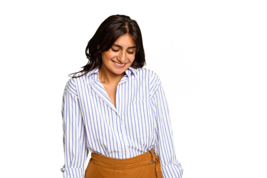 Young Indian woman isolated on green chroma background laughs and closes eyes, feels relaxed and happy.