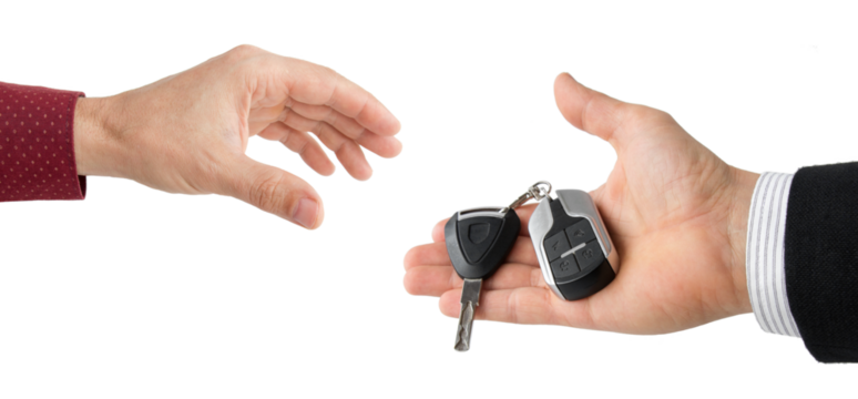 hand of businessman passing car keys to hand, isolated 