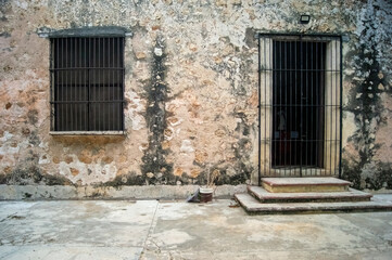 colonial architecture, arches surrounded by vegetation, play of light and shadows inside the space, natural materials
