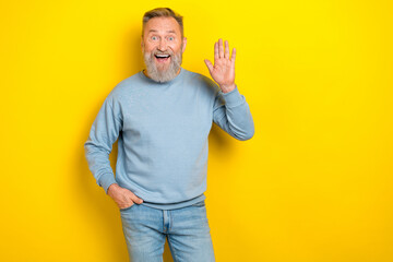 Photo of friendle funny cunning man pensioner dressed blue pullover waving arm palm empty space...