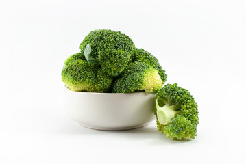 Fresh broccoli in a white cup isolated on white background closeup.