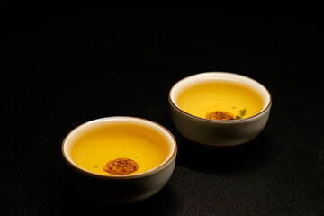 Traditional japanese, chinese asian tea ceremony concept. White ceramic tea cups with lotus on black background. Copy space.
