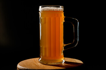 Мug of beer isolated on black background. Space for text