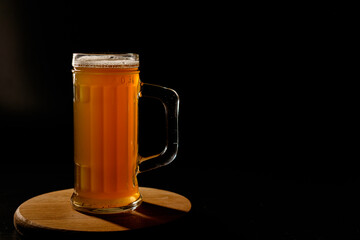 Мug of beer isolated on black background. Space for text