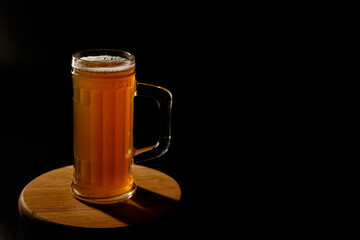 Мug of beer isolated on black background. Space for text