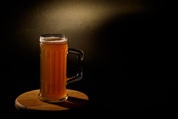  Мug of beer isolated with light in the background.Space for text