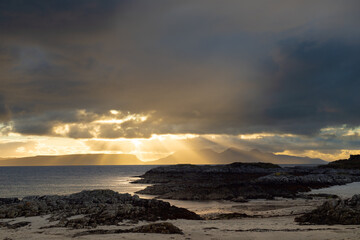 Shafts of sunlight at sunset on a scottish beach