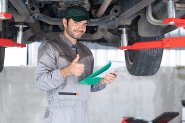Professional mechanic providing car repair and maintenance service in auto garage. Car service business concept.