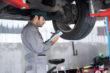 Professional mechanic providing car repair and maintenance service in auto garage. Car service business concept.