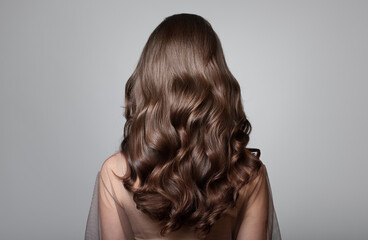 Portrait of a beautiful girl with luxurious curly long hair. Back view. - 535299014