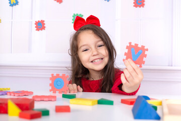 Child learns letters and numbers through play.Portrait of a 4-year-old girl.