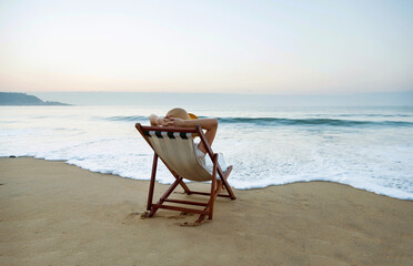 Fototapeta na wymiar Young woman relaxing on the beach.