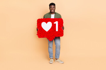 Photo of guy influencer hold pinata heart reaction new post wear shirt denim jeans isolated pastel...