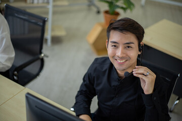 Asian telemarketing agent in call center office