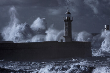 Stormy wave spash in the old river mouth lighthouse