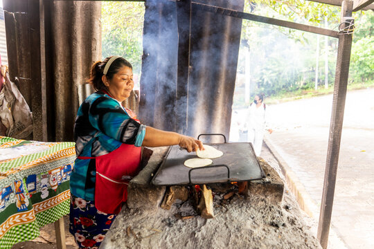 Humble woman from Nicaragua cooking tortillas